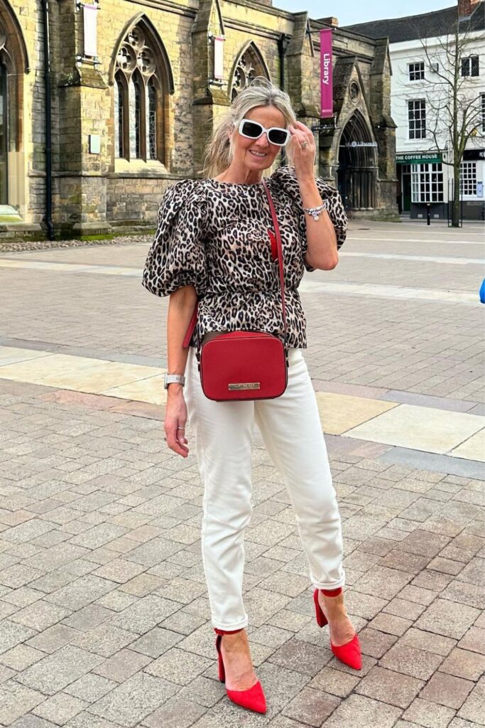 Jeans and Heels Outfit: Animal Print Top, White Jeans and Red Heels