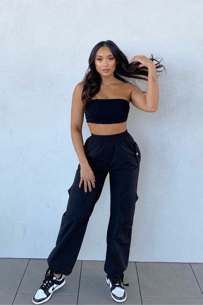 black cargo pant With a Black Tube Top and Black Sneakers