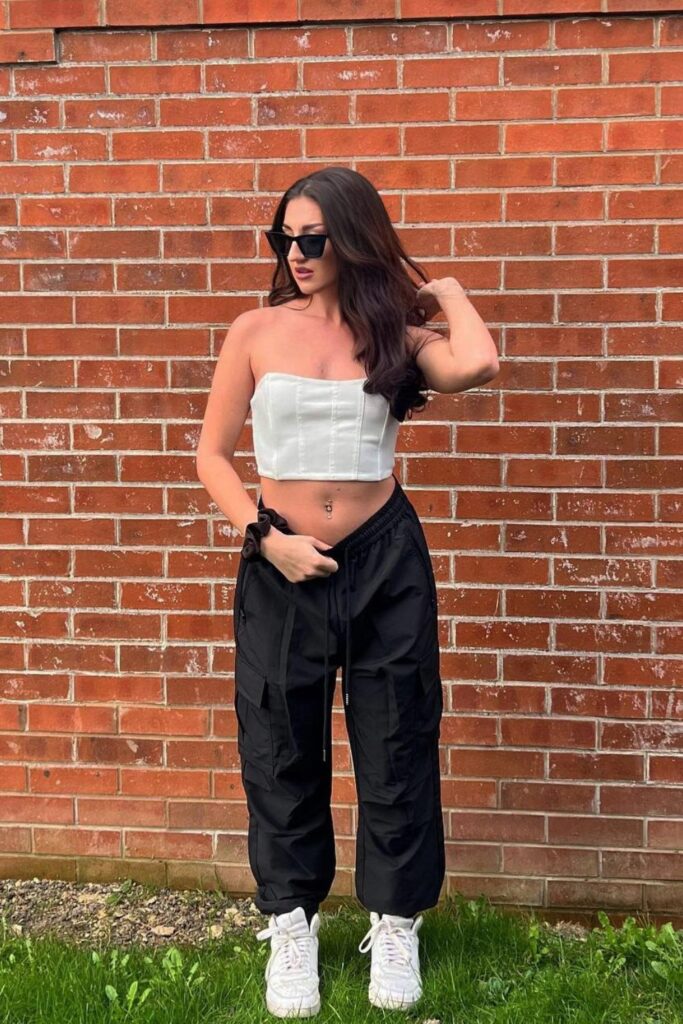 black cargo pant With a White Tube Top and White Sneakers